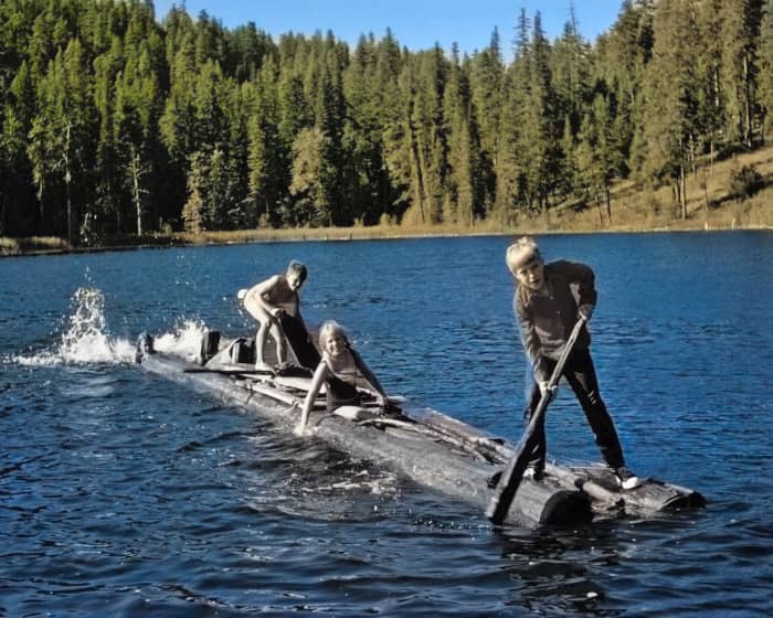 The AI did a good job on the water, the trees and the sky, but it skipped the foreground subjects and their log raft entirely.