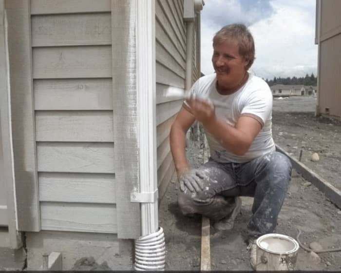 Remember this photo of a painter I showed you earlier? Colorized Photos forgot to color in his hand! Below, I show you how I fix this.