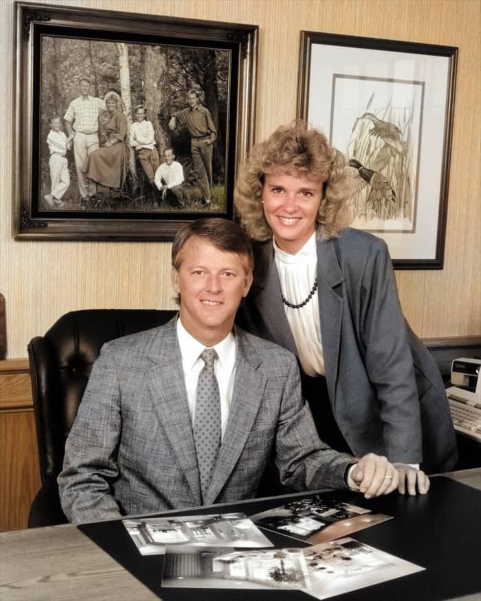 Colorize Photos did a pretty good job with the wall in the background. It even correctly colored the wood paneling. Unfortunately, it missed the subjects' hands.A little manual retouching would greatly improve this.