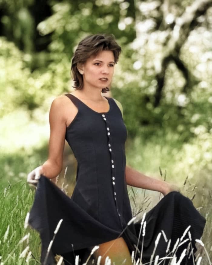 Colorize Photo did a good job on the background foliage and the subject's skin tone, but unfortunately missed her hands, a frequent shortcoming of the algorithm.