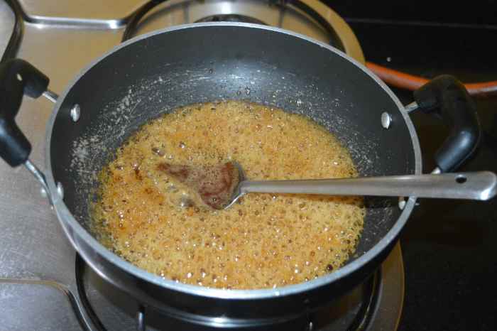 Allow it to boil on low heat until the jaggery syrup becomes thick and gets two-string consistency.