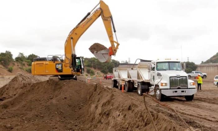 Workers are starting to dig at Devil's Gate Dam. The community protest attempted to save the watershed from being completely stripped to a bare, dirt field. Photo courtesy of LADPW.