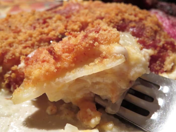 Look at this forkful of scrumptious, cheesy scalloped potatoes! Make your own with this easy-to-follow recipe.