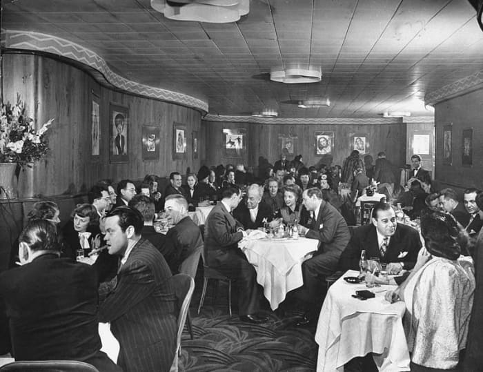A rather stiffly posed image from the Stork Club in 1944. Orson Wells is in the foreground left. Billingsley at the centre table.