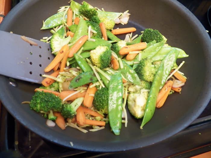 Stir fry vegetables in a non-stick pan. Use non-stick spray or 1 teaspoon of sesame oil for flavor. When vegetables are cooked, take them out of the pan and set them aside.