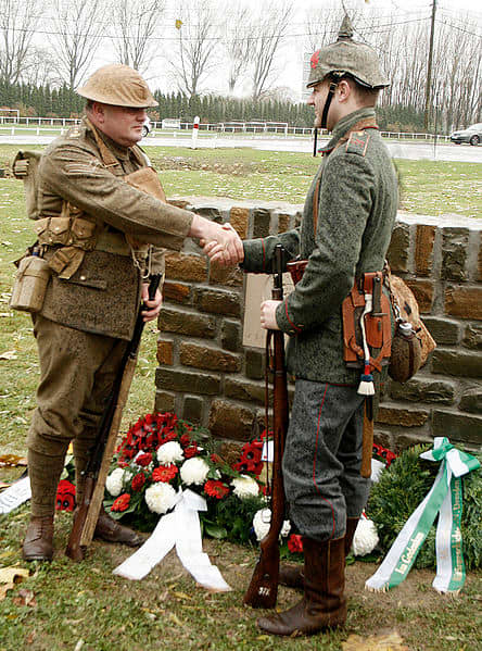 Peter Knight and Stefan Langheinrich, descendants of Great War veterans, shake hands at the 2008 unveiling of a memorial to the 1914 Christmas Truce.