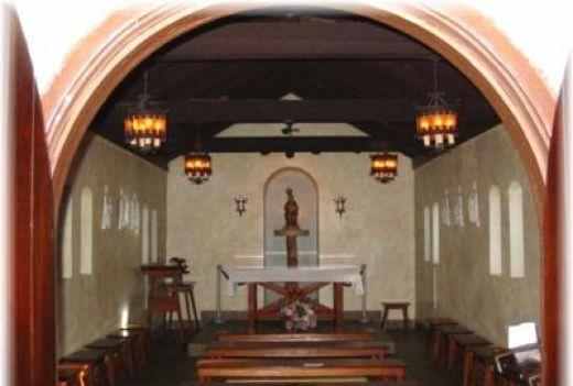 Our Lady of La Leche Church Interior. The ghost of a long dead nun is sometimes seen kneeling at the front of the chapel and some times she walks on the grounds. Many nuns are buried in graves around the church.