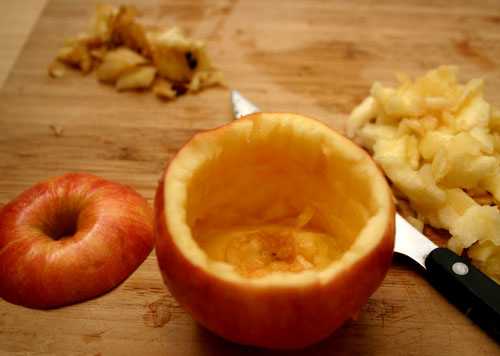 With a sharp paring knife, cut the top off horizontally (so that it makes a lid). Hollow out the apple, and keep all pieces that do not have core or seeds.