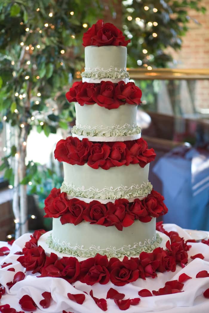 Our "BIG" Wedding Cake: Traditional Fondant in Light Green w/ White Detail; Mixed Flavors: Chocolate, Vanilla, Marble, w/ Raspberry, Chocolate, and Apricot Filling (all tiers); Red Roses