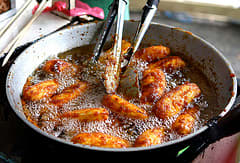 The brown sugar sprinkled on whole bananas while frying becomes the crispy sweet coating. (Photo courtesy by elJeProks from Flickr)