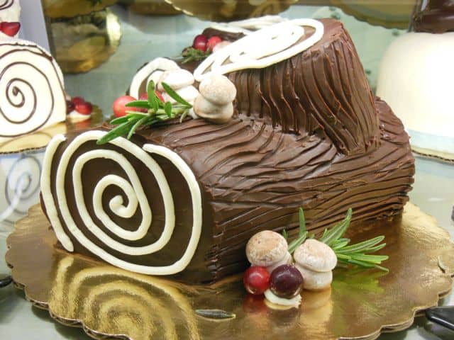 Scoring the icing and adding some meringue mushrooms helps make the cake look more like a real log.