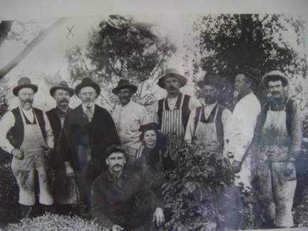 The ghost of the carpenter wearing overalls at the far right has been seen several times at the Winchester Mansion