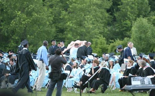 After the beach ball was taken away, students began to pass the blow up doll around during the graduation ceremony.