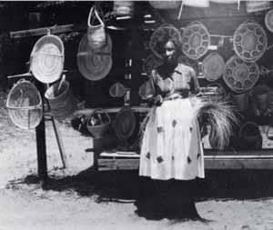 Mrs. Ida Wilson, coastal South Carolina, 1965. Gullah women still offer their baskets for sale along Route 17 north of Charleston. These baskets are constructed almost exactly like the Sierra Leone shukublay.