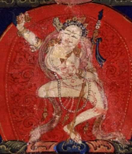 A deity who stands for wisdom. She holds an upraised knife in one hand, a skullcap in another. She stands in a dancing position