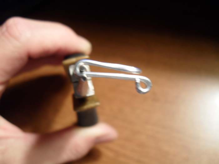 Carefully bend the middle to form a hook. The hairpin tip should lay across the top of the two eyes.