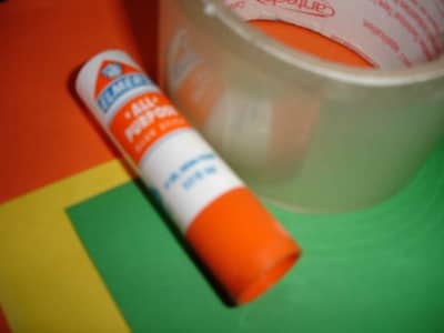 Measure and cut squares of brightly colored paper. (Though the sides are supposedly square, be sure to measure before you cut.)