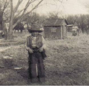 My brother in his full cowboy outfit. I wrote about the time he fell off a saddle that was on a wooden fence. He broke his arm.