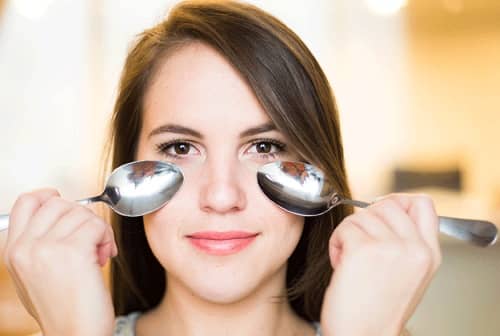 Do not use frozen spoons but cold and compress the back of the spoons over both eyes