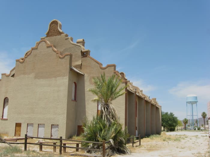 Side view of historic Cook Church and the tall water tower that makes church easy to find in Sacaton, Arizona