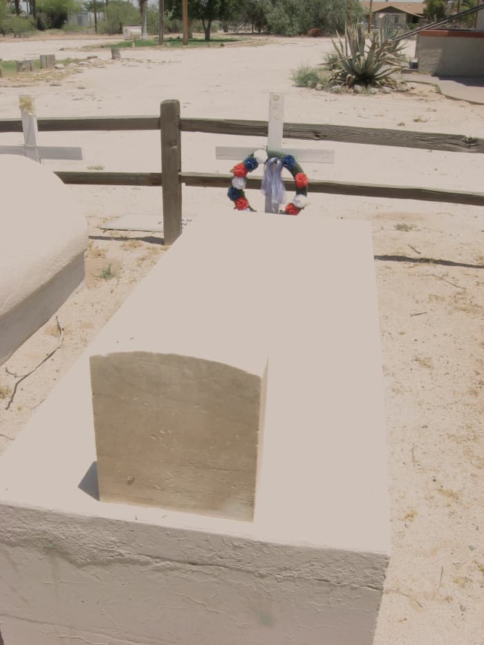 Tomb of WW I Hero, Mathew Juan is decorated with new wreath on grounds of abandoned Cook Memorial Presbyterian Church in Sacaton, AZ