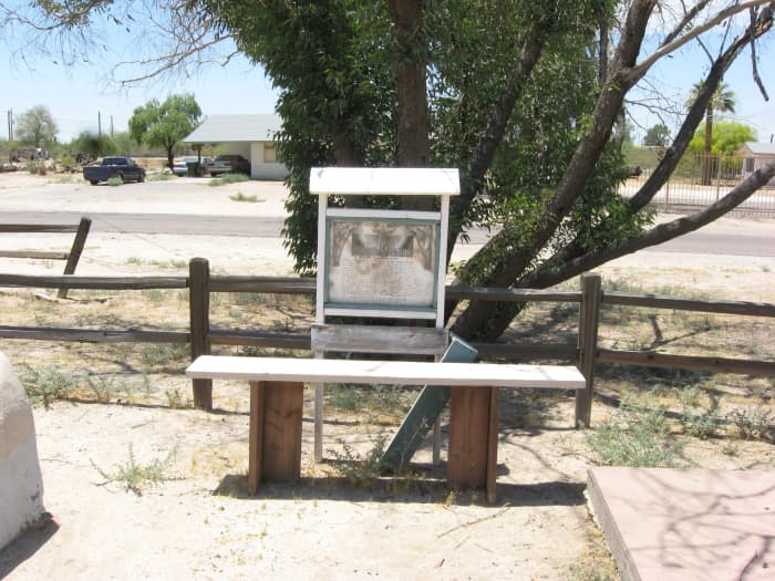 Meditation bench and crumbling information marker in cemetery of the historic Cook Church in Sacaton, Arizona
