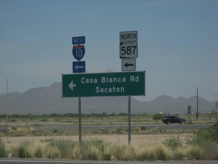 Sign in Arizona desert pointing way to city of Sacaton, Arizona