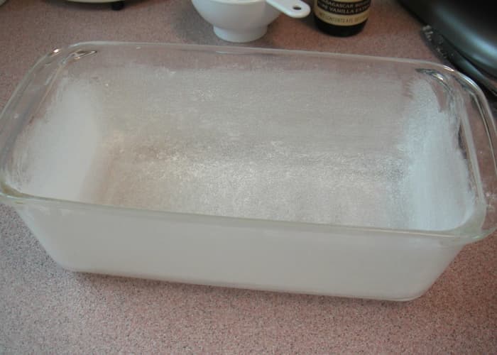 Sprinkle a dusting of flour over the greased pan and distribute the flour evenly shaking out the excess.