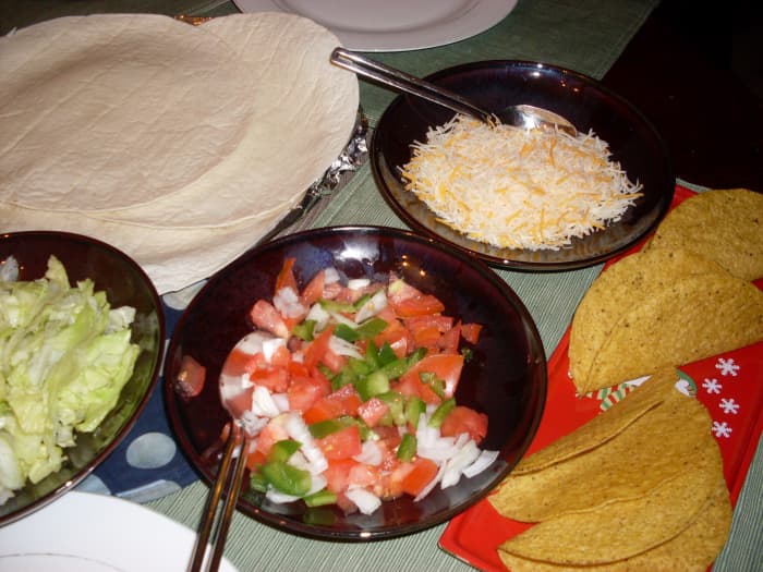 Preparing chicken tacos is a great idea for when you are wondering what to do with leftover chicken. Shredded cheese, onions, red bell peppers, green bell pepper, lettuce and tomatoes are all great fixings for chicken tacos.