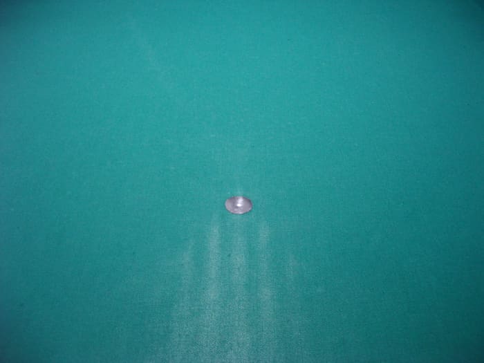 This photograph shows the marks made by pushing the tightened balls up towards the spot, instead of rolling them up.