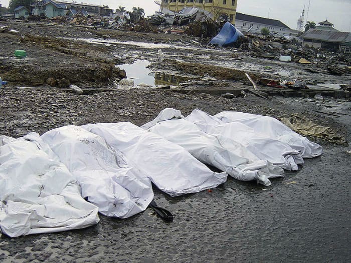 Amid trash and debris, the shrouded bodies of the deceased lay on a street in downtown Banda Aceh, Sumatra, Indonesia, following the massive Tsunami that struck the area on December 26, 2004.