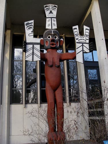 The Wild Woman holds three COPPERS. that traditionally contain all the wealth of the chief. Pieces of the coppers in this artwork have been removed to represent purchases or challenges against wrongdoers.