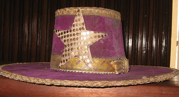 Eyo Agere Hat - The purple hat with a star emblem with gold dots, and a gold band is worn by the Eyo Agere masquerades.