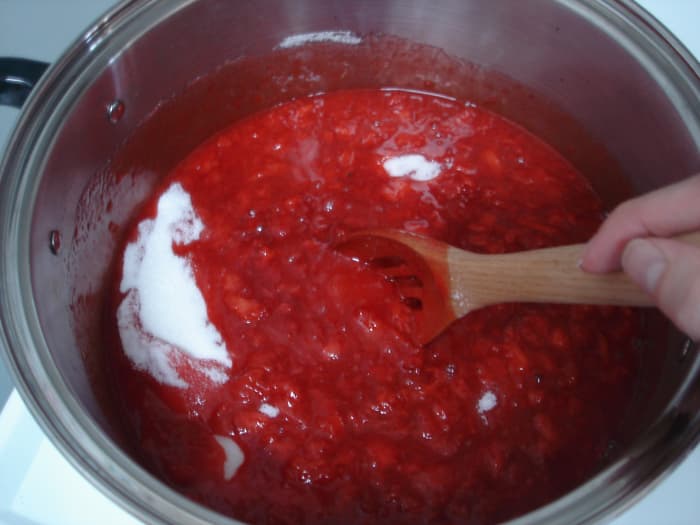 Step 2: In a large kettle, combine the strawberries, pectin, and butter. Bring to a boil over medium heat, stirring occasionally.