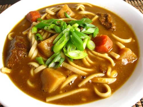 Udon is a noodle dish made from wheat noodles that uses kelp or tuna flakes to get the soup stock (dashi). In curry udon like here, one can add curry to the udon to enjoy the curry more like a soup.