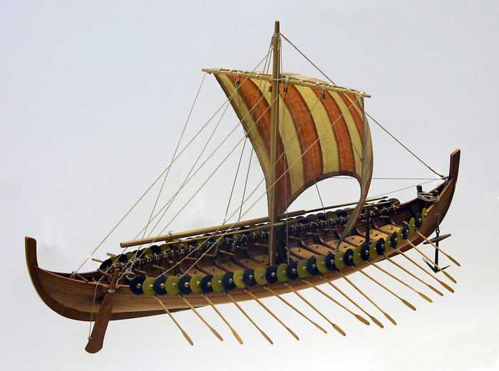A model of the Gokstad ship. The shields would have been taken in before the oars were run out for rowing. Also, if the sail was up and full with the wind there would be no need for the oars to be in their holes. Modeller's license.