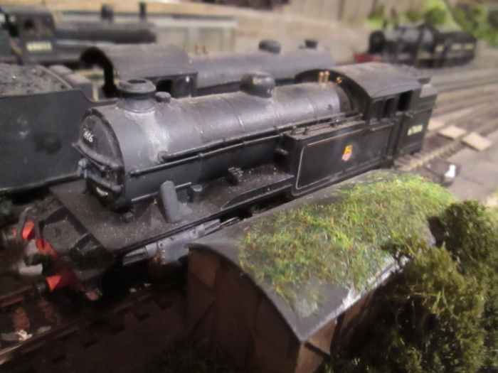 Class V3 67686 (Bachmann, re-numbered with HMRS transfers) of 51D rests between duties at sub-shed Ayton Lane beside a grounded van body (tool shed)