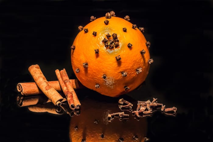 Cloves in arranged in oranges and placed throughout the home creates subtle scent from the essential oil of the orange and the clove.