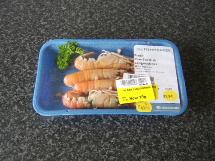 Unsold fresh langoustines, drastically reduced in price from £1.54 to £0.19 - an incredible bargain but a sad sign of consumer shopping patterns