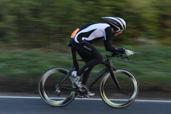 Play around with camera settings to blur the background in your cycling photo's. Shutter speed 1/60 sec, f value 5.6, ISO 200