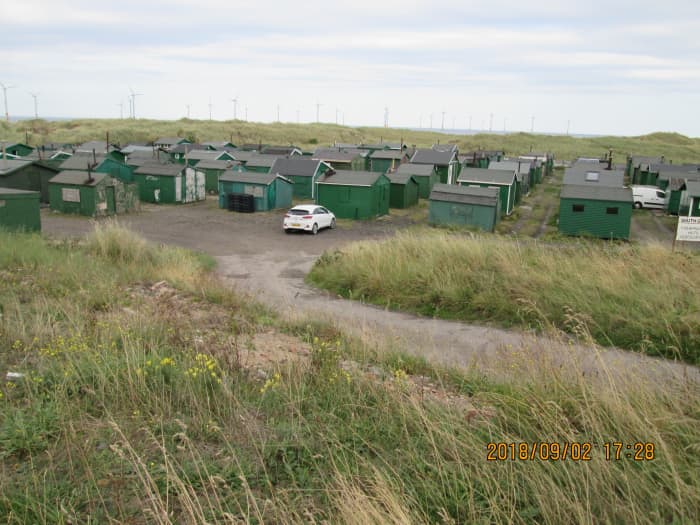 Across the causeway, on the south side of the gare in a dip is this ordered concentration of fishermen's huts