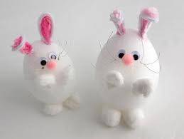 CUTE BUNNIES MADE WITH EGG-SHAPED FOAM BODIES, WHITE POM-POMS, A PINK POM-POM NOSE, GOOGLE EYES, AND WHITE AND PINK FOLDED PIPE-CLEANER EARS