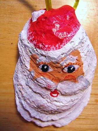 To make a fancy ornament, you can glue white cotton to the face for a beard, eyebrows, and hair or a ball on Santa's hat.
