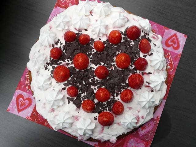 This is a beautifully decorated Million Dollar Pie. It has whole strawberries and dark chocolate shavings on it.