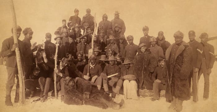 Buffalo soldiers of the 25th Infantry, some wearing buffalo robes, Ft. Keogh, Montana; 1890.