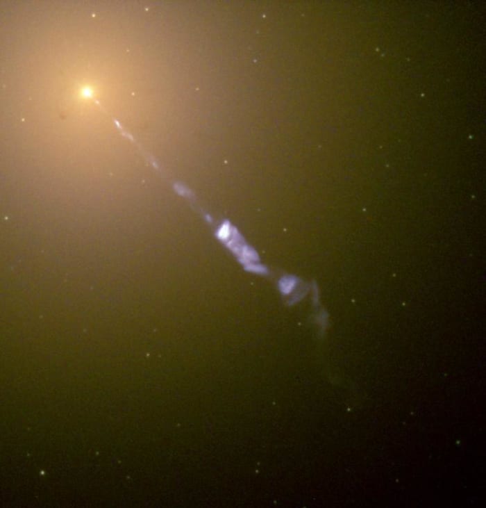 The black hole at the center of galaxy M87 emits "A black-hole-powered jet of electrons and other sub-atomic particles traveling at nearly the speed of light."
