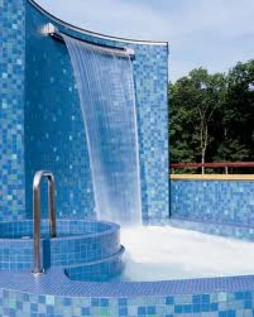 other swimming pool amenities such as an outdoor shower - this one is exceptional with its cascading water fountain and blue glass