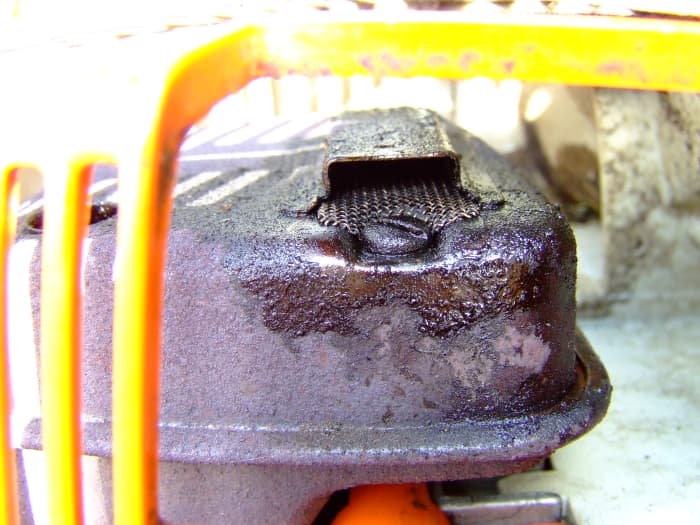 Just remove the screw in the exhaust and slid the screen out with a pair of needle nose pliers. Clean the screen with carburetor cleaner and a wire brush, or just replace it with a new screen.