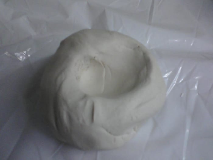 Start by making a depression in the ball of clay with the thumbs, placing the fingers on outside of ball, begin pinching fingers and thumbs together