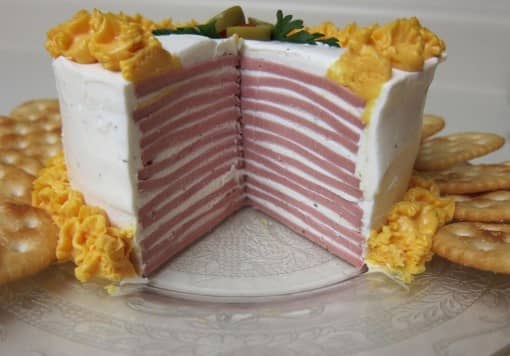 Baloney Cake: Baloney layered in between a mixture of cream cheese and ranch dressing, along with aerosol sharp cheddar cheese and crackers. Bring this to your next party!
